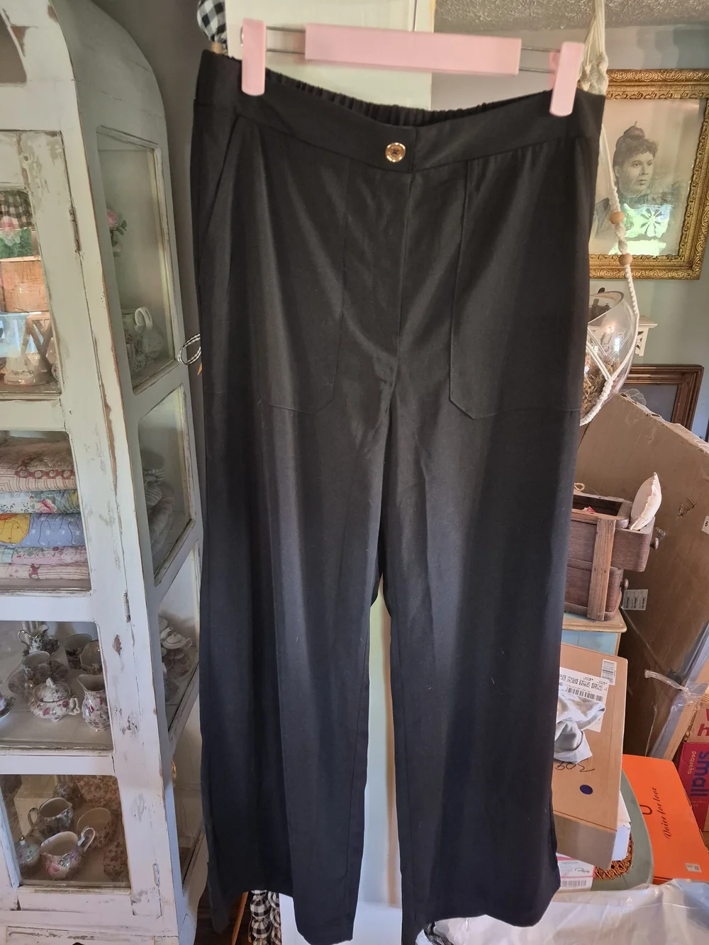 Michael Kors black wide-leg trousers featuring prominent front patch pockets